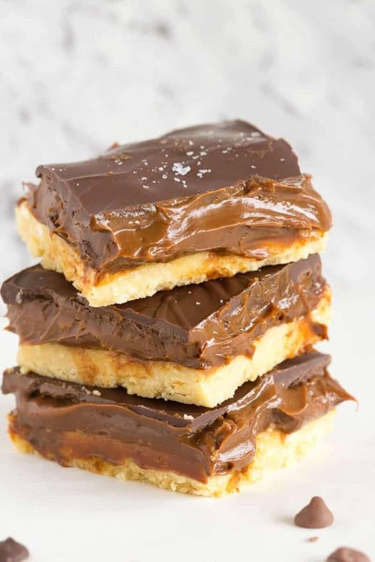 My homemade millionaire shortbread features a buttery crust, gooey caramel filling, and a thick layer of chocolate. They make the best no bake caramel dessert.